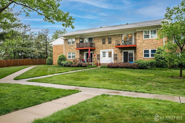 view of front of property with a balcony and brick siding