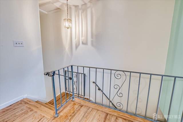stairs with wood finished floors and baseboards
