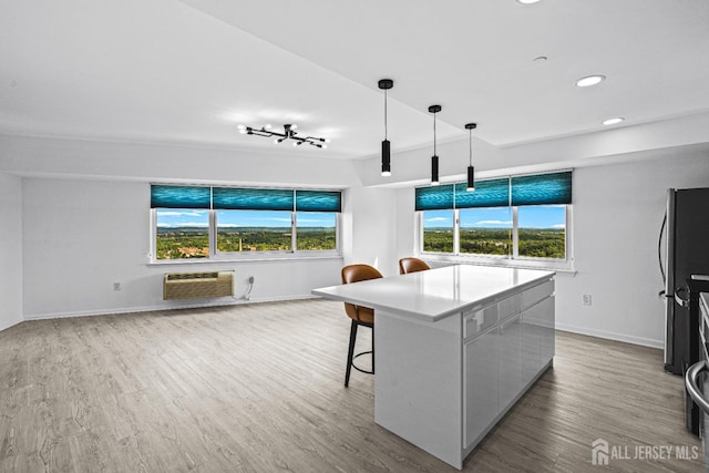 110 Somerset St Unit 2114, New Brunswick, NJ 08901 - kitchen with an AC wall unit, wood finished floors, healthy amount of natural light, baseboards, and recessed lighting