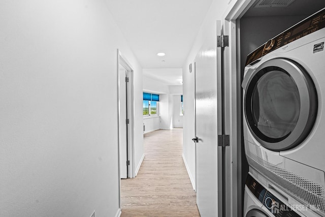 110 Somerset St Unit 2114, New Brunswick, NJ 08901 - laundry room featuring stacked washing machine and dryer, baseboards, light wood finished floors, and recessed lighting