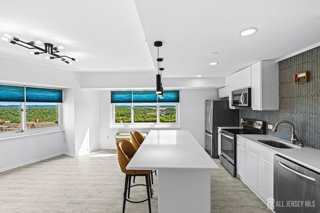 110 Somerset St Unit 2114, New Brunswick, NJ 08901 - kitchen featuring appliances with stainless steel finishes, a sink, light wood-style flooring, white cabinets, and recessed lighting