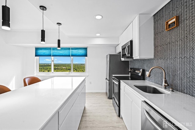 110 Somerset St Unit 2114, New Brunswick, NJ 08901 - kitchen with appliances with stainless steel finishes, a sink, recessed lighting, white cabinetry, and light wood-type flooring
