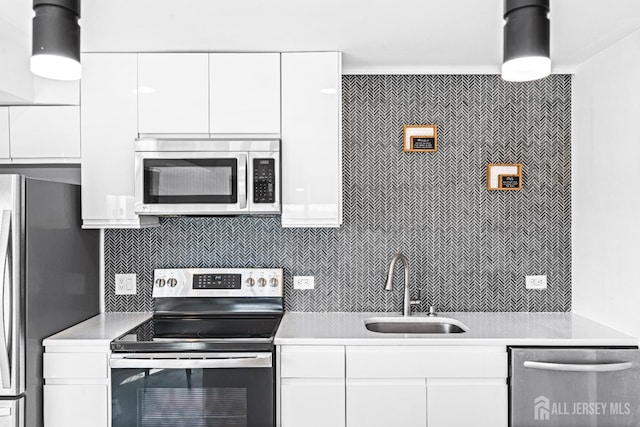110 Somerset St Unit 2114, New Brunswick, NJ 08901 - kitchen featuring stainless steel appliances, a sink, light countertops, and white cabinets