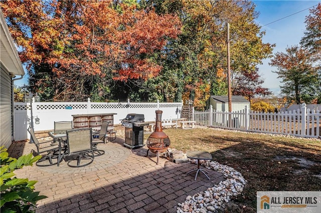 view of patio featuring area for grilling and a fire pit