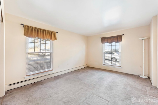carpeted spare room featuring a baseboard radiator