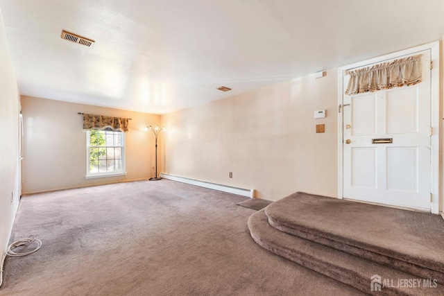 carpeted spare room with baseboards, baseboard heating, and visible vents