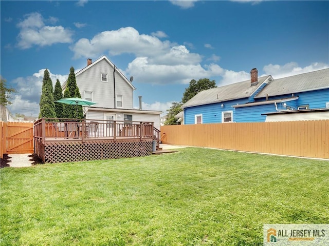 15 Leland Ave, South River, NJ 08882 - back of house featuring a fenced backyard, a deck, and a chimney