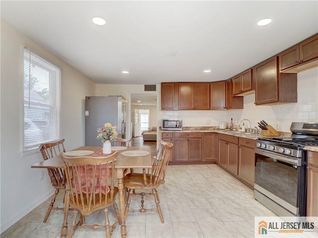15 Leland Ave, South River, NJ 08882 - kitchen with stainless steel appliances, recessed lighting, tasteful backsplash, and brown cabinets