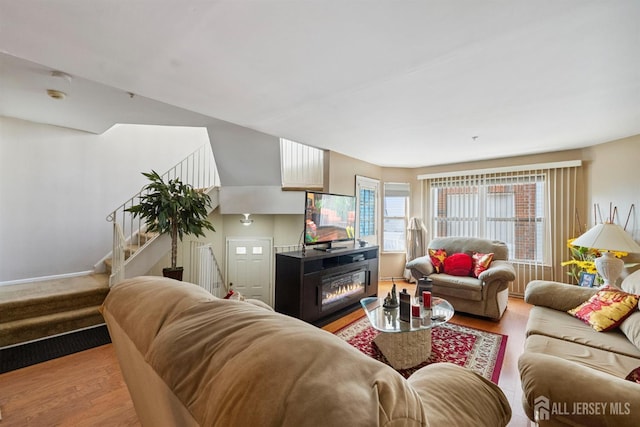 816 Harbortown Blvd Unit 816, Perth Amboy, NJ 08861 - living room featuring wood finished floors, stairs, and a lit fireplace