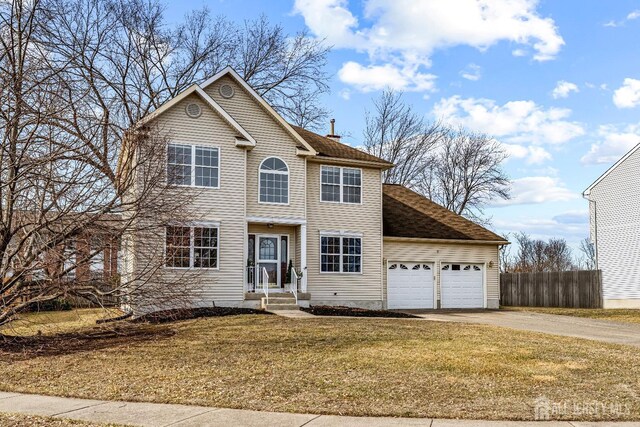 view of front of home with a garage and a front yard