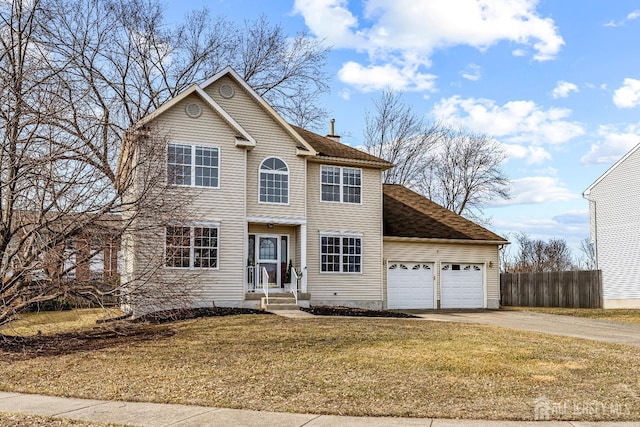 view of front of home with a garage, a front lawn, driveway, and fence