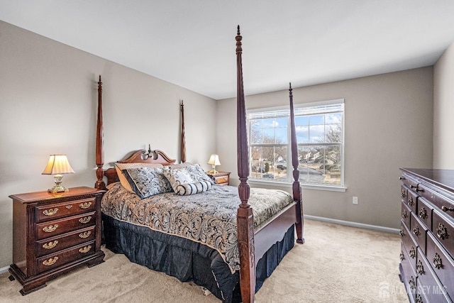 bedroom featuring baseboards and light carpet