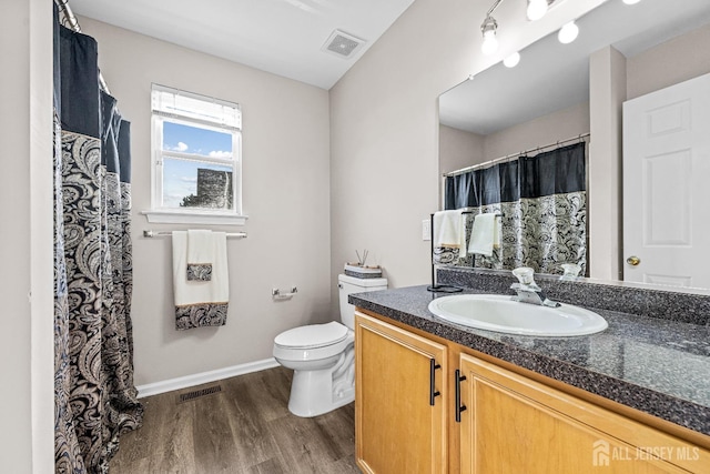 full bath featuring visible vents, toilet, vanity, and wood finished floors