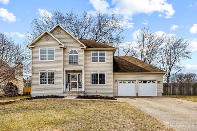 view of front of property with a garage and a front yard