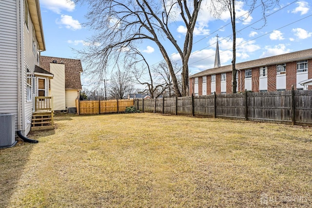 view of yard featuring central air condition unit and a fenced backyard