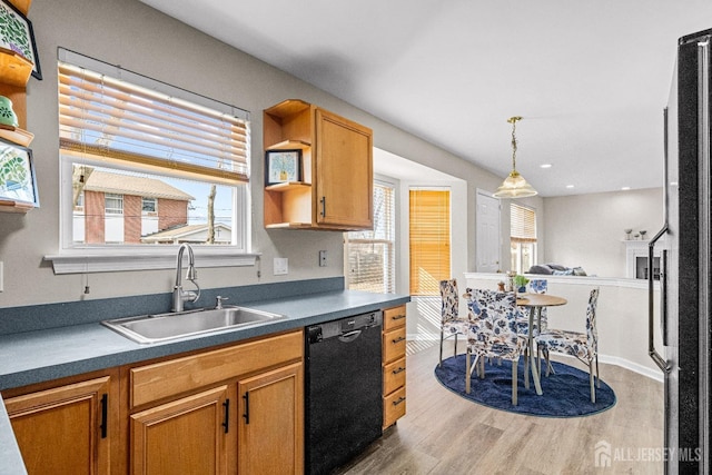 kitchen with dishwasher, open shelves, dark countertops, and a sink