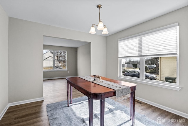 home office featuring an inviting chandelier, wood finished floors, and baseboards