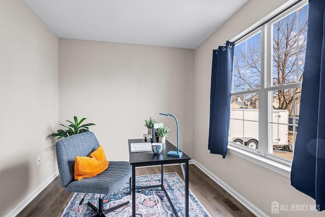 office area featuring visible vents, dark wood-type flooring, and baseboards