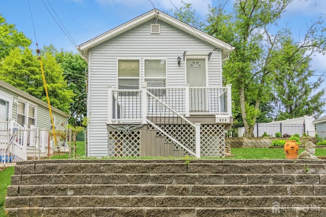 view of front of property featuring stairs and fence