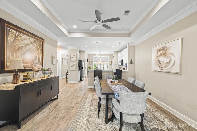 6 Traditions Pl, Monroe, NJ 08831 - dining space featuring light wood-type flooring, ceiling fan, recessed lighting, crown molding, and a tray ceiling