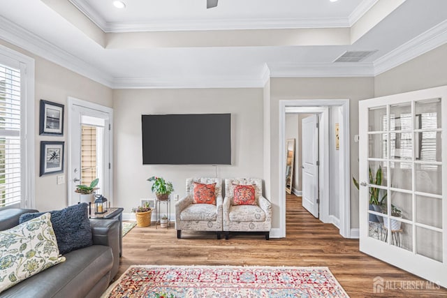 6 Traditions Pl, Monroe, NJ 08831 - living area with a tray ceiling, healthy amount of natural light, wood finished floors, crown molding, and recessed lighting