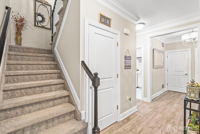 6 Traditions Pl, Monroe, NJ 08831 - staircase with ornamental molding, wood finished floors, and a chandelier