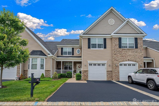 6 Traditions Pl, Monroe, NJ 08831 - multi unit property with stone siding, driveway, a front yard, and an attached garage