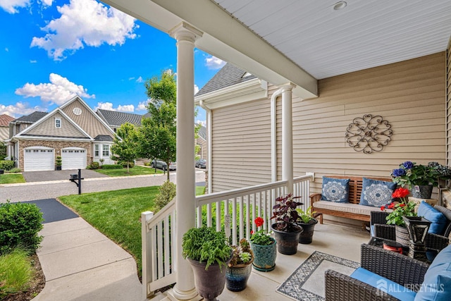 6 Traditions Pl, Monroe, NJ 08831 - covered porch featuring a lawn, an attached garage, and an outdoor living space