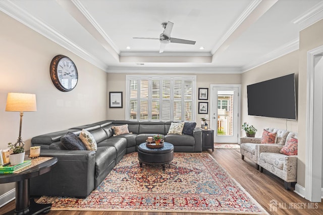 6 Traditions Pl, Monroe, NJ 08831 - living area featuring a tray ceiling, plenty of natural light, wood finished floors, a ceiling fan, and crown molding