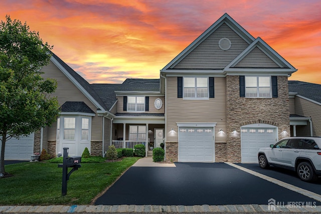 6 Traditions Pl, Monroe, NJ 08831 - view of property featuring stone siding, driveway, a yard, and an attached garage