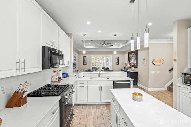 6 Traditions Pl, Monroe, NJ 08831 - kitchen with appliances with stainless steel finishes, ornamental molding, a tray ceiling, light wood-type flooring, and recessed lighting