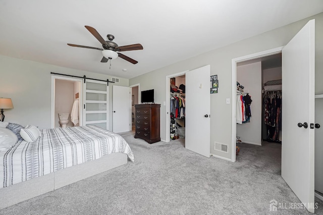 30 Forest Garden Dr, Old Bridge, NJ 07747 - bedroom with a walk in closet, a closet, carpet flooring, a barn door, and a ceiling fan