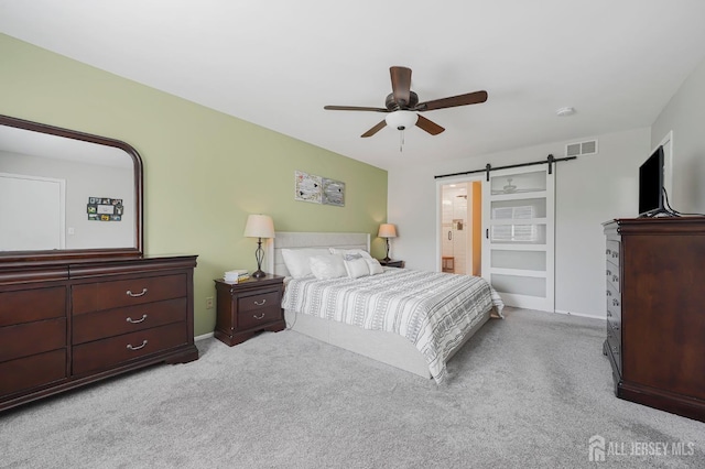 30 Forest Garden Dr, Old Bridge, NJ 07747 - carpeted bedroom with a barn door, ceiling fan, and ensuite bath