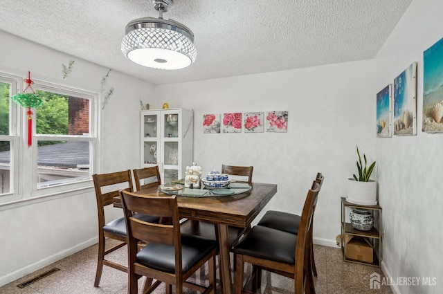 9 Merion Dr, Manalapan, NJ 07726 - dining area featuring a textured ceiling and baseboards