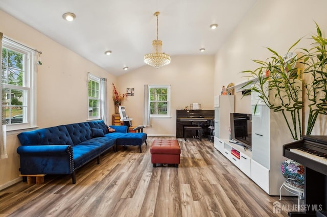 9 Merion Dr, Manalapan, NJ 07726 - living area featuring light wood-type flooring, plenty of natural light, a chandelier, and lofted ceiling