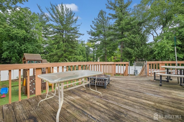 9 Merion Dr, Manalapan, NJ 07726 - deck with outdoor dining space, a playground, and view of scattered trees