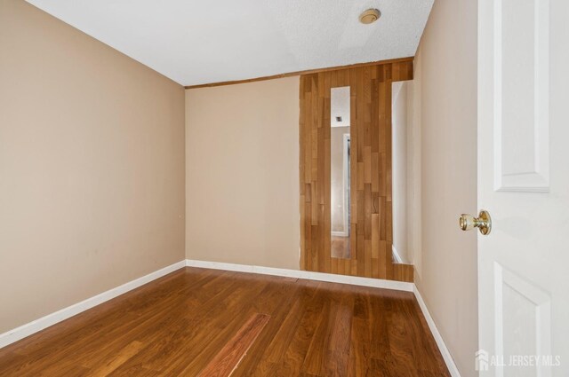 9 Merion Dr, Manalapan, NJ 07726 - unfurnished room featuring wood finished floors, a smoke detector, and baseboards
