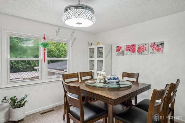 9 Merion Dr, Manalapan, NJ 07726 - dining space with baseboards, a textured ceiling, and granite tiled floors