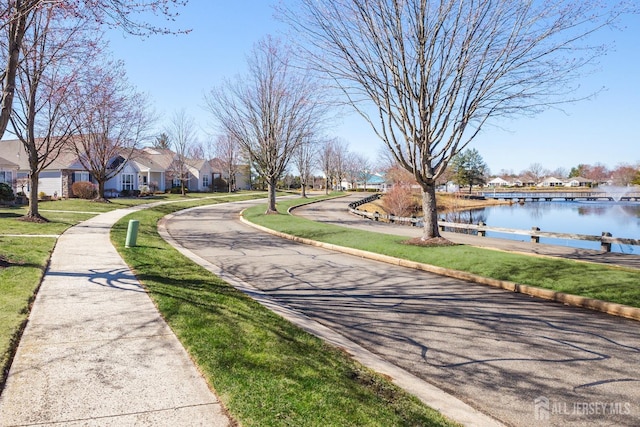 543 Waterside Blvd, Monroe, NJ 08831 - view of asphalt street with a residential view, a water view, curbs, and sidewalks