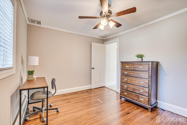office with ceiling fan, crown molding, light wood-style floors, and visible vents