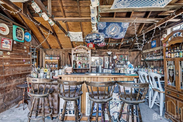 bar featuring lofted ceiling and a dry bar