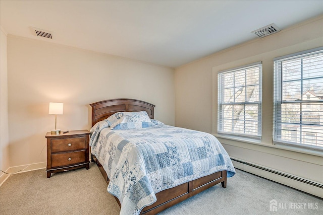 bedroom featuring light colored carpet, a baseboard heating unit, crown molding, and visible vents