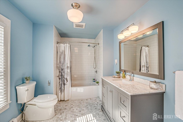 full bathroom with visible vents, toilet, vanity, and shower / bath combo with shower curtain