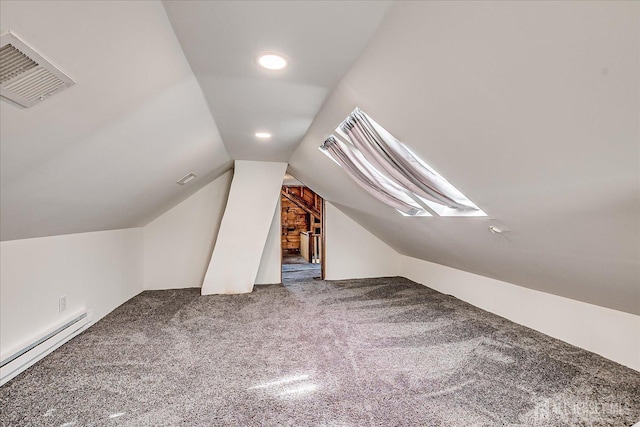 additional living space with visible vents, carpet flooring, a baseboard heating unit, and lofted ceiling