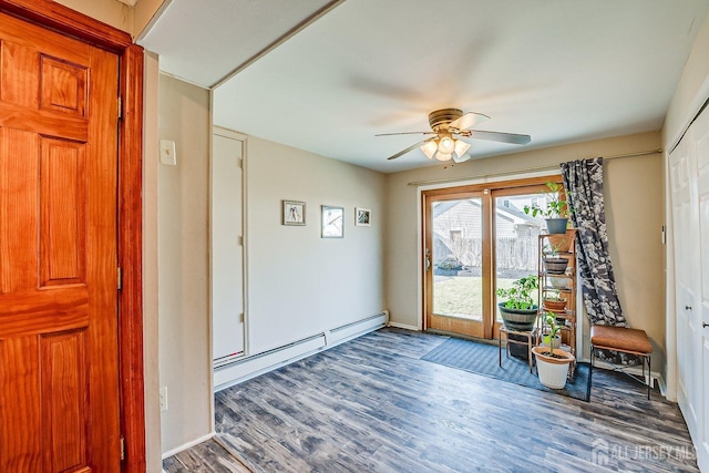 doorway to outside featuring a baseboard heating unit, wood finished floors, baseboards, and ceiling fan