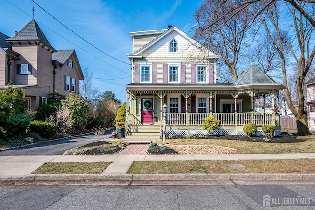 victorian house with a porch and driveway