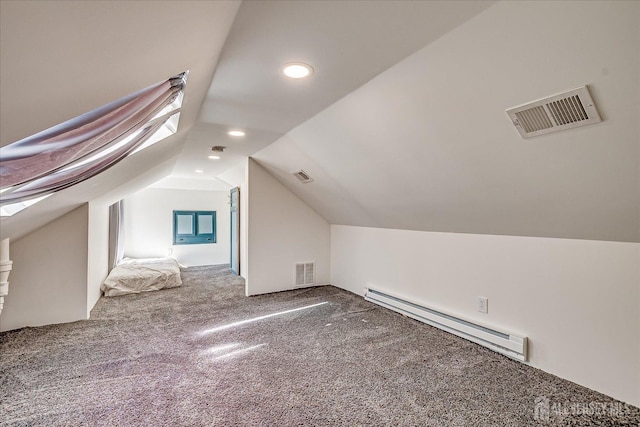 additional living space featuring a baseboard heating unit, lofted ceiling, carpet, and visible vents