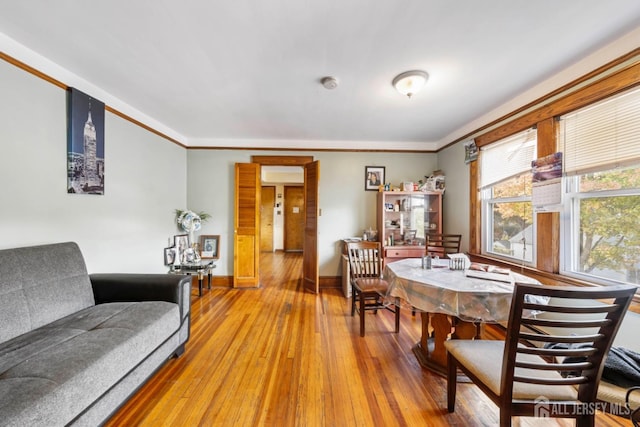 dining room featuring hardwood / wood-style floors and ornamental molding