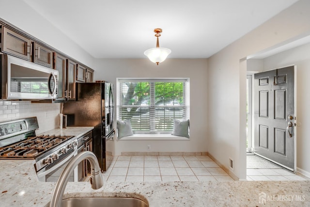 362 Aldeburgh Ave, Franklin Twsp, NJ 08873 - kitchen featuring appliances with stainless steel finishes, light tile patterned floors, pendant lighting, decorative backsplash, and dark brown cabinets