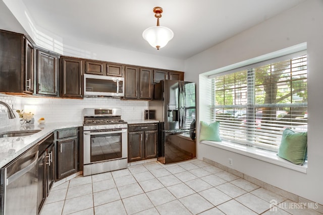 362 Aldeburgh Ave, Franklin Twsp, NJ 08873 - kitchen featuring appliances with stainless steel finishes, a sink, decorative backsplash, light stone countertops, and dark brown cabinetry